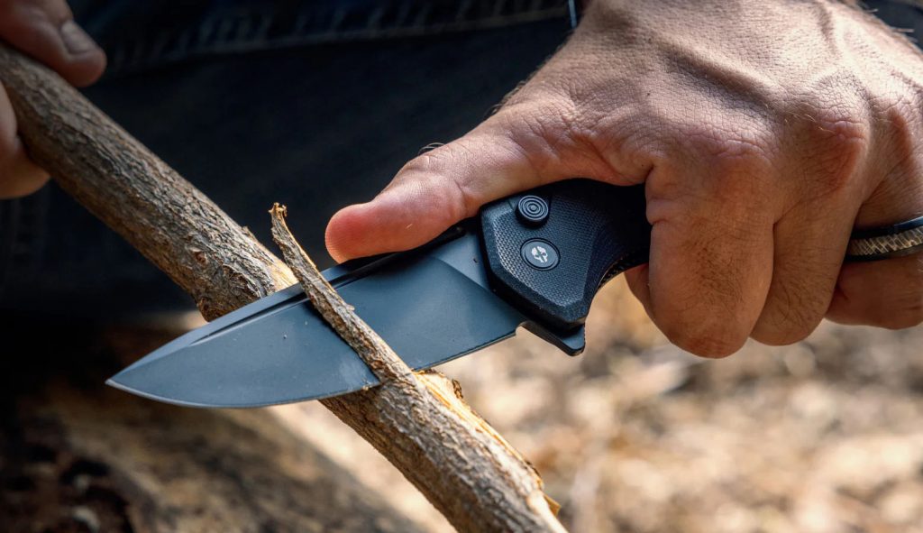Tekto folding knife cutting wood